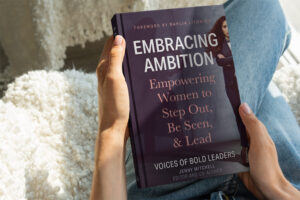 Undistinguishable person reading Embracing Ambition